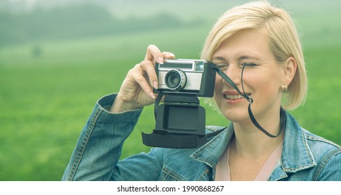 Close Up Portrait Of Beautiful Blonde Female Photojournalist Traveling And Taking Picture Outdoors