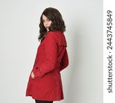 close up portrait of beautiful brunette woman model, wearing red trench coat jacket.
isolated on white studio background. 
posing with back view, turning away from camera.