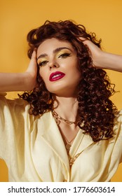 Close Up Portrait Of Beautiful Curly Woman With Bold Color Eyes, Lips Makeup Posing On Yellow Background