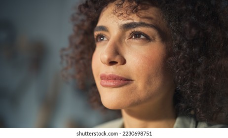 Close Up Portrait of a Beautiful Female Creative Specialist with Curly Hair Smiling. Young Successful Multiethnic Arab Woman Working in Art Studio. Dreaming About Better Life and Opportunities Ahead. - Powered by Shutterstock