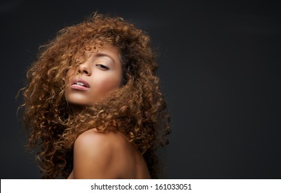 Close up portrait of a beautiful female fashion model with curly hair