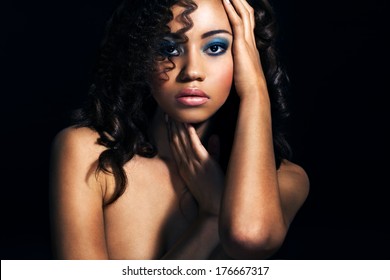 Close up portrait of a beautiful female fashion model with curly hair.Portrait of an African American Black Woman.Beauty.Space