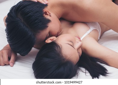 Close up portrait of beautiful half naked couple is embracing in the bed room, true love and feelings, gentle touch and caress, woman's day