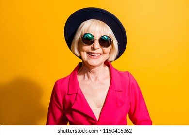 Close up portrait of beautiful and happy blond hair grandma looking at camera isolated on yellow background - Powered by Shutterstock