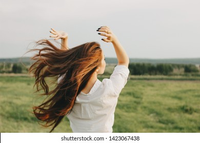 Close Up Portrait Of Beautiful Long Hair Girl In White Clothes In Field, View From Back. Sensitivity To Nature Concept