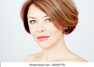 Close Up Portrait Of Beautiful Middle Aged Woman With Short Brown Hair, Red Lips And Fresh Makeup Over White Background  - Beauty Concept