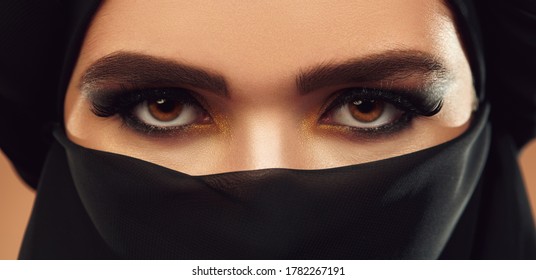 Close up portrait of a beautiful muslim woman in black clothes and  hijab. Oriental beauty, fashion. Make-up and cosmetics.  - Shutterstock ID 1782267191