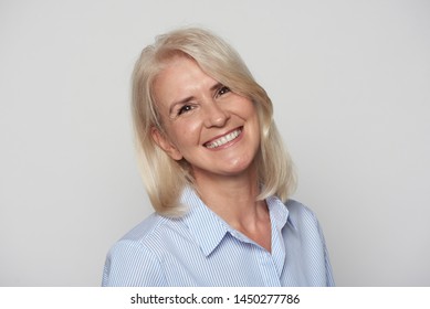 Close Up Portrait Of Beautiful Older Woman Smiling Isolated On Grey Background