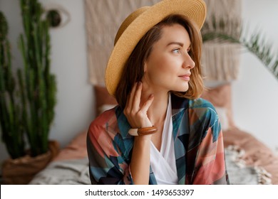 Close up portrait of beautiful romantic woman in straw hat chilling over bohemian interior.woo accessories. - Powered by Shutterstock