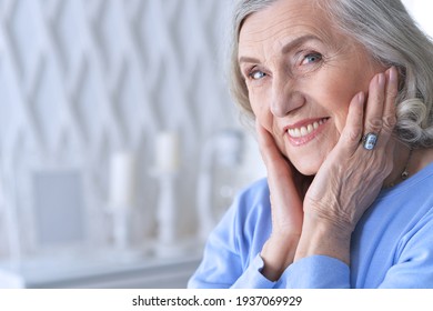 Close up portrait of beautiful senior woman posing at home
