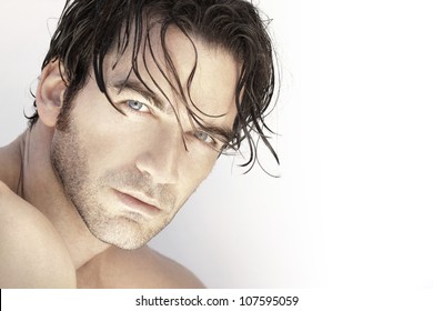 Close Up Portrait Of A Beautiful Sexy Male Model Face Against White Background