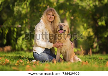 Similar – Pretty blond woman with her two dogs