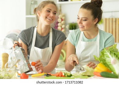 Close Up Portrait Of Beautiful Teenagers Cooking In Kitchen