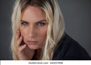 Close up portrait of beautiful transgender woman against gray background - Powered by Shutterstock - Get 15% off with code: PIKWIZARD15