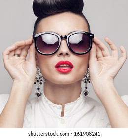 Close Up Portrait Of Beautiful Vintage Styling Model Wearing Round Black Sunglasses. Updo, Large Earrings. Square