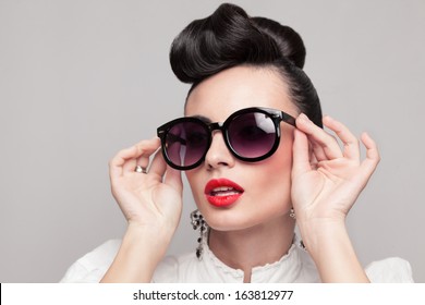 Close Up Portrait Of Beautiful Vintage Styling Model Wearing Round Black Sunglasses. Updo, Large Earrings