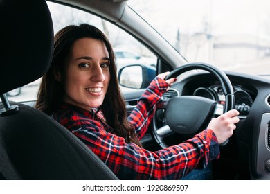 Close up portrait of beautiful woman driving her new car