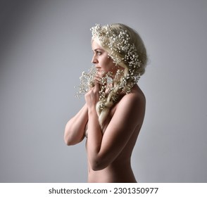 Close up portrait of beautiful women with long blonde hair, wearing white fantasy princess ball gown, holding pretty baby breath flowers,  isolated on white studio background