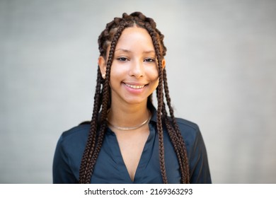 Close Up Portrait Of Beautiful Young African Woman With Braided Hair Smiling At Camera