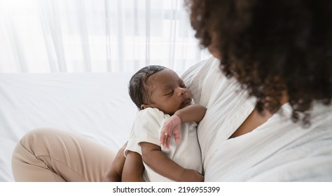 Close Up Portrait Of Beautiful Young African American  Mother Holding Sleep Newborn Baby In Hospital. Healthcare Medical Love Black Afro Woman Lifestyle Mother's Day, Breast Concept With Copy Space. 