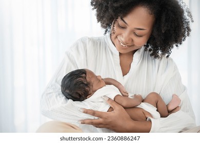 Close up portrait of beautiful young African American  mother holding sleep newborn baby in hospital bed room. Healthcare medical love black afro woman lifestyle mother's day, breast with copy space.  - Powered by Shutterstock