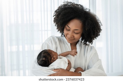 Close up portrait of beautiful young African American  mother holding sleep newborn baby in hospital bed room. Healthcare medical love black afro woman lifestyle mother's day, breast with copy space.  - Powered by Shutterstock