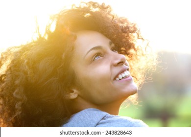 Close up portrait of a beautiful young african american woman smiling and looking up