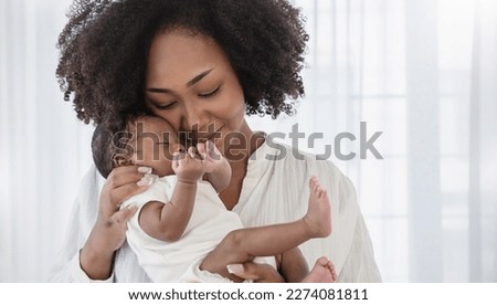 Close up portrait of beautiful young African American  mother holding sleep newborn baby in hospital bed room. Healthcare medical love black afro woman lifestyle mother's day, breast with copy space. 