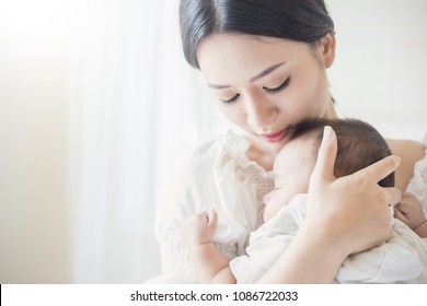 Close Up Portrait Of Beautiful Young Asian Indian Or Caucasian Mother Day With Newborn Baby, Copy Space With Bed In The Hospital Background. Healthcare And Medical Love, Lifestyle Mother's Day Concept