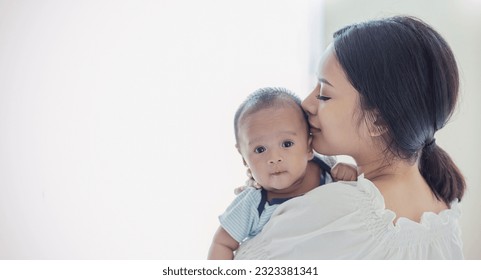 Close up portrait of beautiful young asian or caucasian mother day kissing her newborn baby in hospital. Healthcare and medical love asia woman lifestyle mother's day concept with copy space.  - Powered by Shutterstock