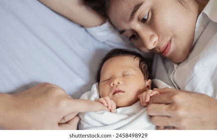 Close up portrait of beautiful young asian caucasian mother day girl kissing healthy newborn baby sleep in bed with copy space. Healthcare and medical love asia woman lifestyle mother's day banner - Powered by Shutterstock