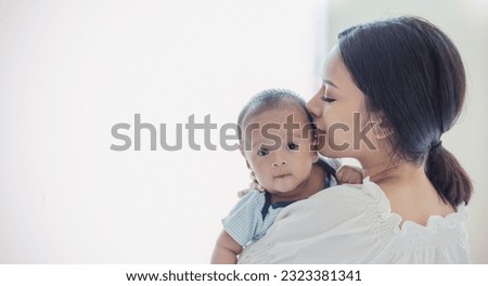 Close up portrait of beautiful young asian or caucasian mother day kissing her newborn baby in hospital. Healthcare and medical love asia woman lifestyle mother's day concept with copy space. 