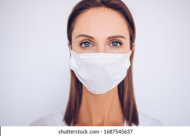 Close Up Portrait Of Beautiful Young European Woman Doctor Nurse Wearing Protective Mask Corona Virus Prevention. Free Space For Text Mockup Banner. Avoid Contaminating Corona Virus Covid-19 Concept