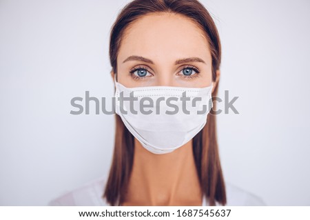 Close up portrait of beautiful young european woman doctor nurse wearing protective mask corona virus prevention. Free space for text mockup banner. Avoid contaminating Corona virus Covid-19 concept