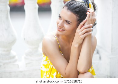 Close up portrait of beautiful young lady. Pretty woman walking outdoors. Elegant female in yellow dress. - Shutterstock ID 1716518713