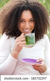 Close Up Portrait Of A Beautiful Young Woman Drinking Mint Tea Outdoors