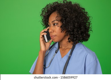 Close Up Portrait Of Black Female Doctor On Serious Phone Call. Nurse On The Phone, Listening