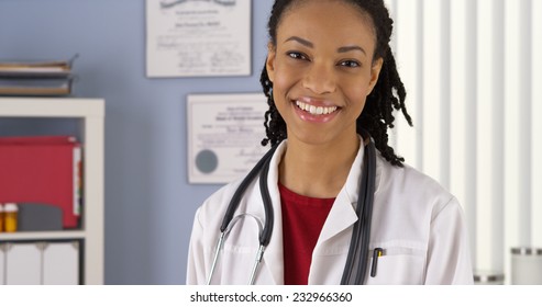 Close Up Portrait Of Black Female Doctor Smiling In Medical Clinic