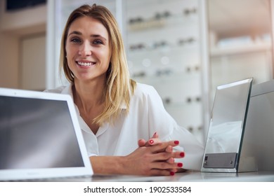 Close up portrait of blonde Caucasian female in white business clothes looking and posing at the photo camera in office ophthalmology - Shutterstock ID 1902533584