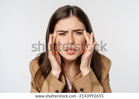 Close up portrait of business woman squinting and looking without glasses, cant see, bad sight without eyewear, standing over white background