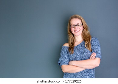 Close Up Portrait Of A Business Woman Standing Against Gray Background With Arms Crossed