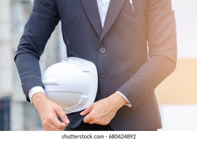 Close Up Portrait Of Businessman Holding Safety Helmet