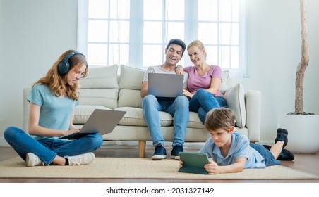 Close up portrait of caucasian family parents daughter and son sit on sofa living room hands using smart phones technology. Together leisure time isolation, home quarantine stay together concept 