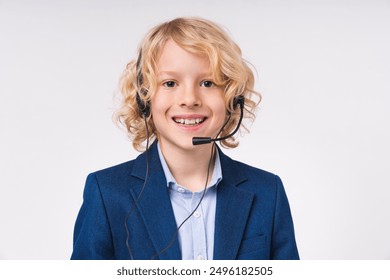 Close up portrait of a caucasian little preteen boy male child kid elementary primary middle school pupil teenager in formal clothes uniform wearing operator`s headset isolated over white background - Powered by Shutterstock