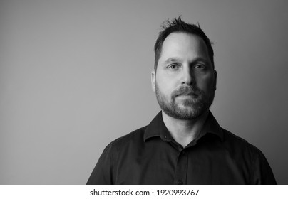 Close Up Portrait Of A Caucasian Man. The Portrait Is Black And White. 