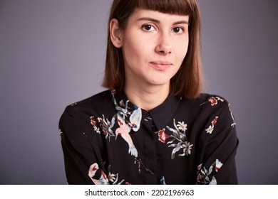 Close Up Portrait Of Caucasian Millennial Female. Grey Backgound. Face Of Eastern European 30s Female Model 