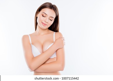 Close up portrait of charming beautiful attractive sexy nude woman with no-make-up closed eyes showing her big breast isolated on white background copy-space
