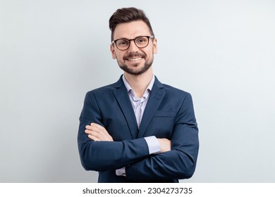 Close up portrait of a cheerful man in glasses and dark blue suit. Isolated on grey background - Powered by Shutterstock