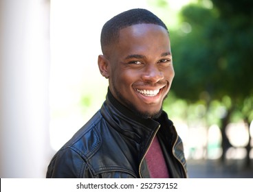 Close Up Portrait Of A Cheerful Young African American Man Smiling Outside