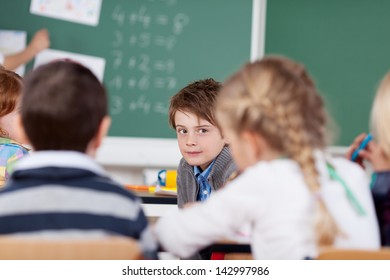 Close Up Portrait Of Children Talking In The Classroom